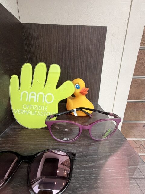 Nano Kinderbrille mit Sonnenclip und Gummienten-Deko im Schaufenster von Meller Optic